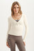 Woman wearing a cream long-sleeve top and brown leggings on a white background <model-info>Maranda wears a size XS and is 5’10”, 24½” waist, 33” bust.</model-info>