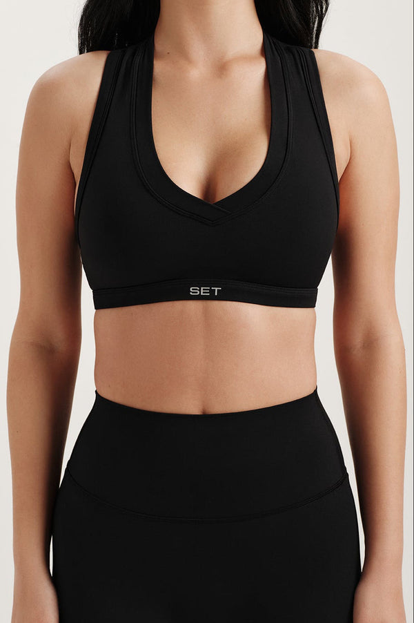 Black sports bra with 'SET' branding on a plain background