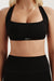 Black sports bra with 'SET' logo on a neutral background