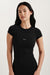 Woman wearing a black t-shirt with a logo on a white background <model-info>Jasmine wears a size XS and is 5’8, 25” waist, 32C bust.</model-info> 