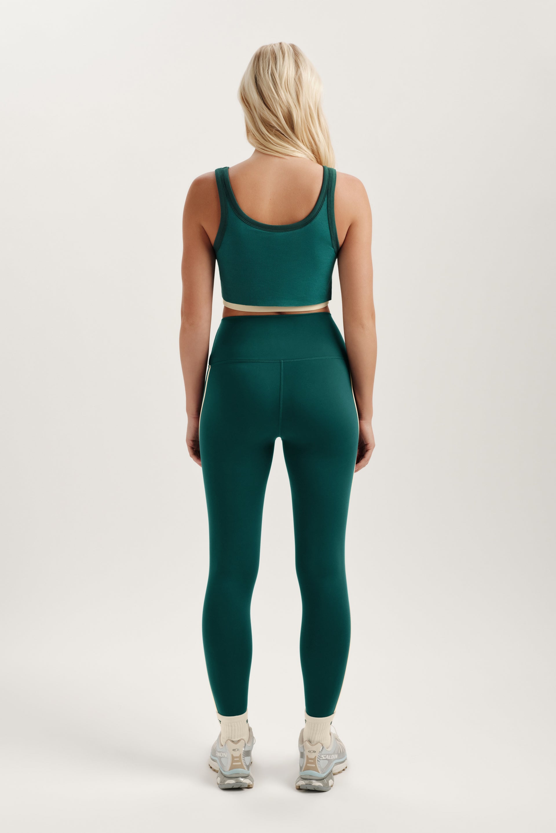 Person wearing a green athletic outfit on a white background