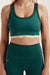 Green sports bra and leggings with 'SET' branding on a neutral background