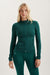 Woman wearing a green athletic outfit on a light gray background <model-info>Kenzie wears a size S and is 5’6, 25” waist, 33” bust.</model-info> 