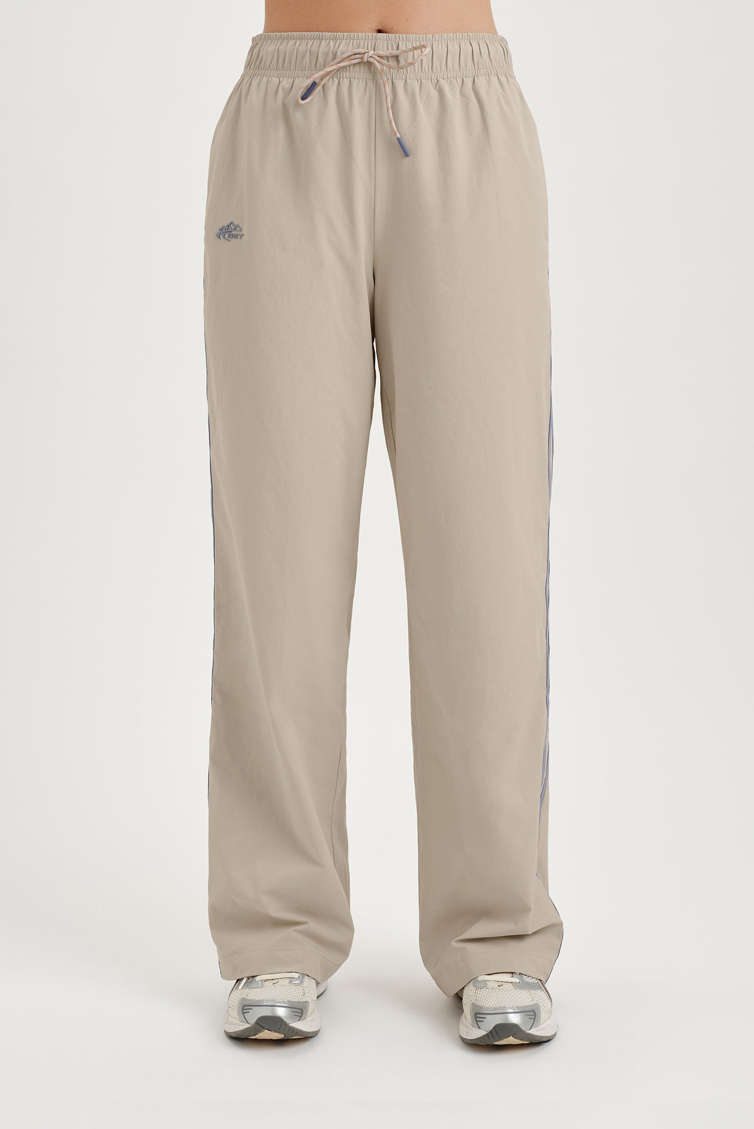 Beige track pants on a white background 