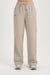 Beige track pants on a white background <model-info>Kathryn wears a size S and is 5’8½ , 24” waist, 33B bust.</model-info> 