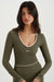 Woman wearing a green athletic outfit with a visible brand logo on a white background <model-info>Meeya wears a size XS and is 5’7, 23” waist, 32B bust.</model-info> 