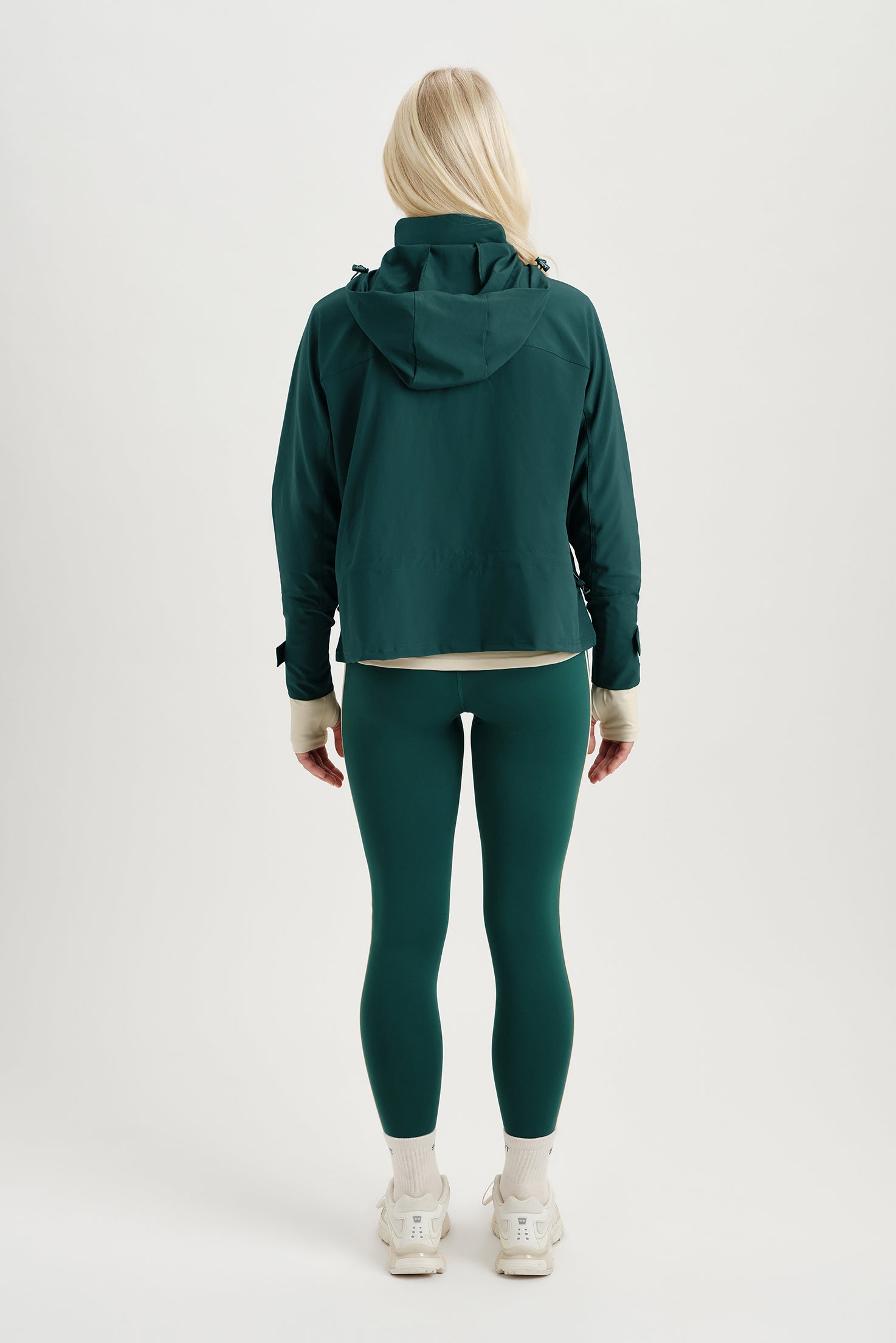 Person wearing a green tracksuit on a white background