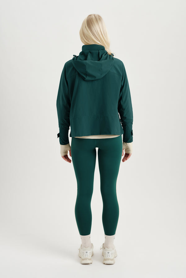 Person wearing a green tracksuit on a white background