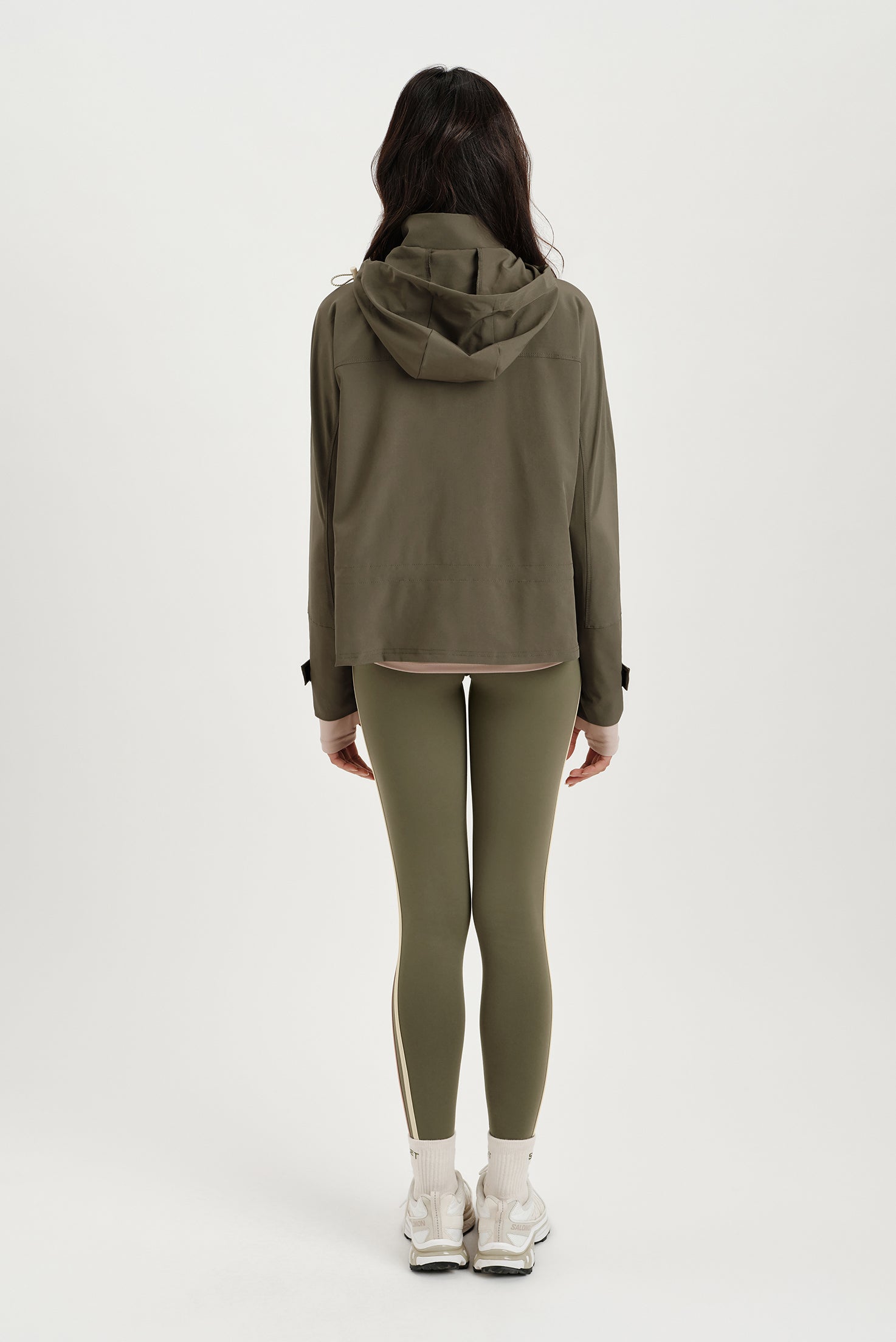 Person wearing a green tracksuit on a white background