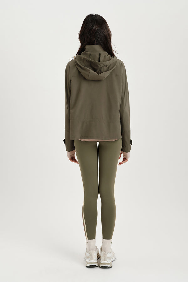 Person wearing a green tracksuit on a white background