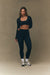 Woman wearing a black athletic outfit on a beige background