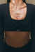 Black long-sleeve crop top with 'SET' branding on a neutral background
