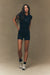 Woman wearing a black athletic outfit on a beige background