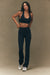 Woman wearing a black sports bra and leggings on a beige background <model-info>Jelene wears a size XS and is 5’7”, 23” waist, 32AB bust.</model-info>