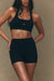 Woman wearing a black sports bra and shorts set on a beige background