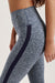 Gray leggings with a navy stripe on a neutral background