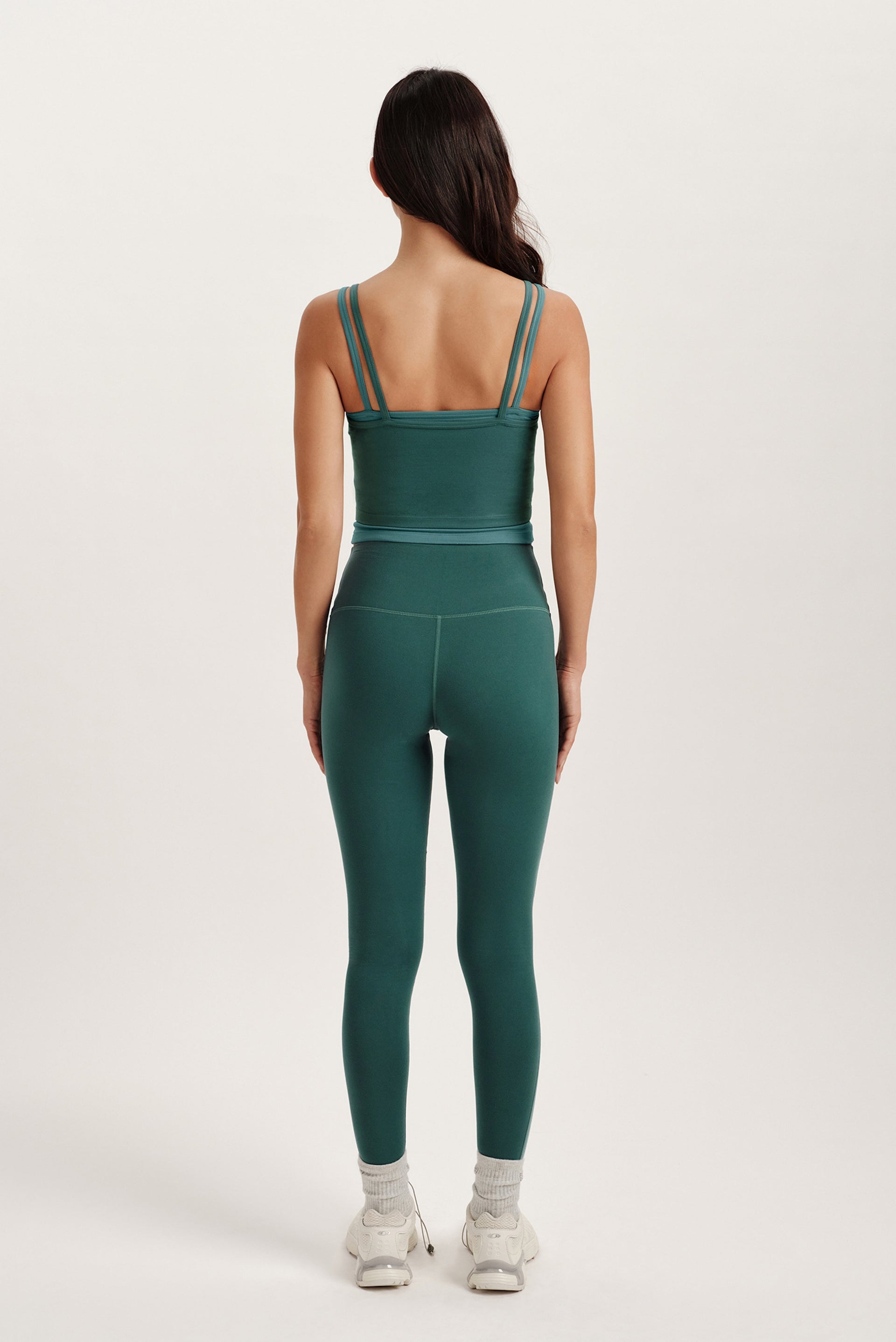 Person wearing a green athletic outfit on a white background