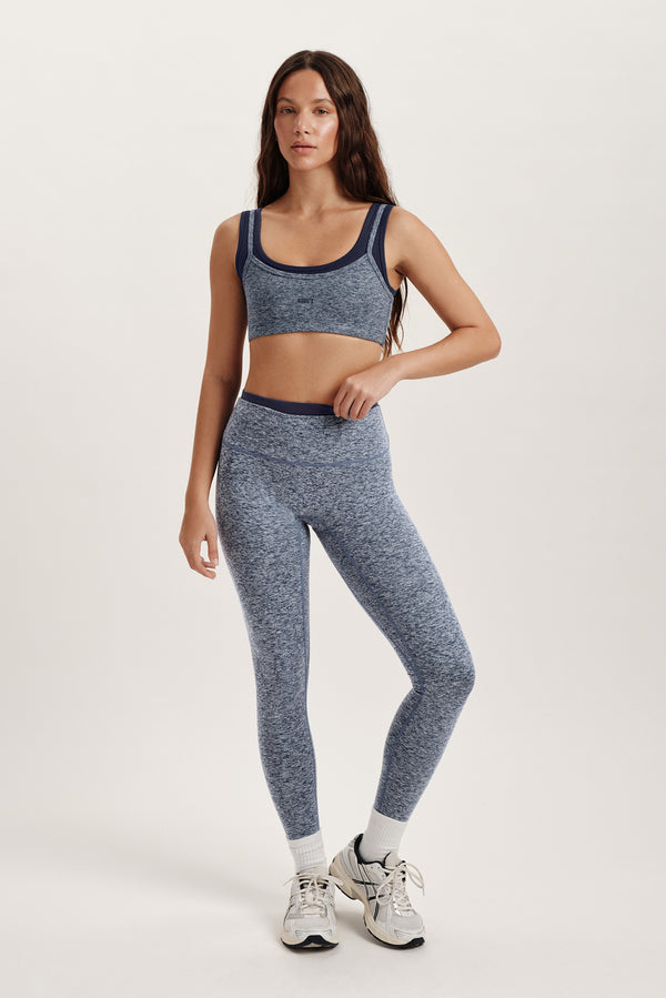 Woman wearing a blue athletic outfit on a white background