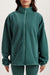 Green fleece jacket worn by a person on a light beige background