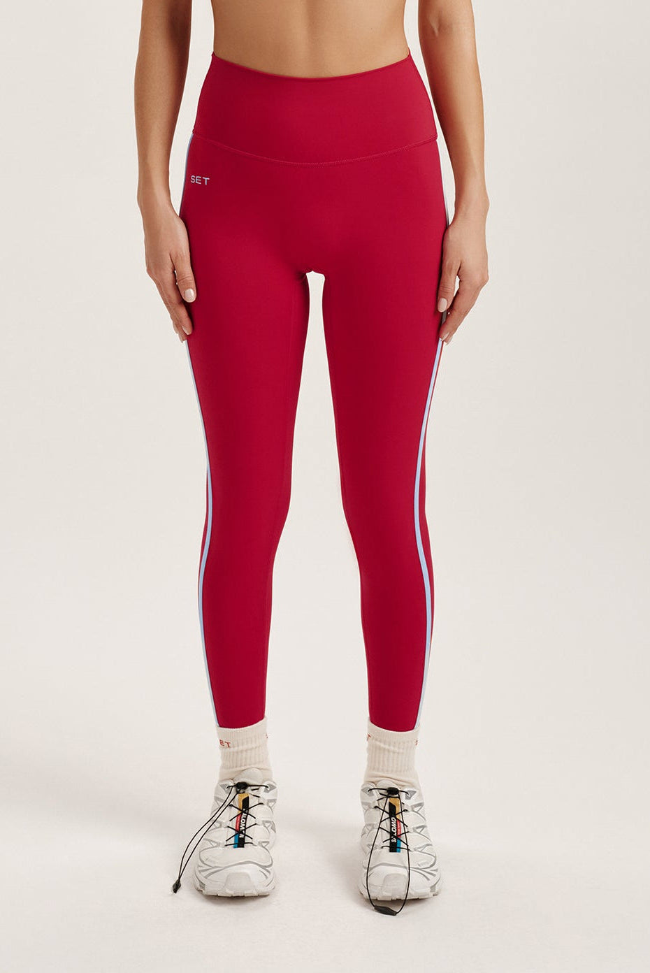 Woman wearing red leggings on a light gray background <model-info>Jocelyn wears a size S and is 5’9, 23” waist, 32B bust.</model-info> 