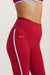 Red leggings with a blue stripe and 'SET' logo on a beige background