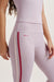 Light pink athletic leggings with a red stripe and 'SET' branding on a white background