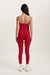 Person wearing a red athletic set with thin straps on a white background