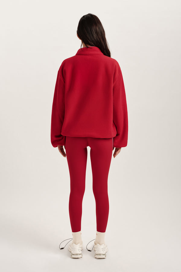 Person wearing a red outfit on a white background