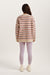 Person wearing a striped sweater and light purple leggings on a white background
