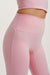 Pink leggings with a subtle brand logo on a light background