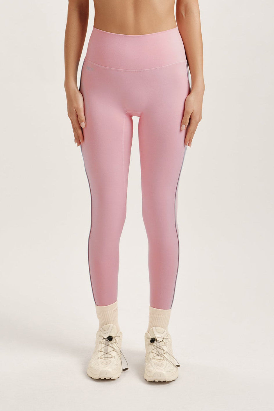 Woman wearing a pink leggings on a white background <model-info>Jocelyn wears a size S and is 5’9, 23” waist, 32B bust.</model-info> 