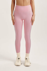 Woman wearing a pink leggings on a white background 