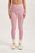 Woman wearing a pink leggings on a white background <model-info>Jocelyn wears a size S and is 5’9, 23” waist, 32B bust.</model-info> 