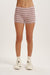 Person wearing striped shorts on a plain background
