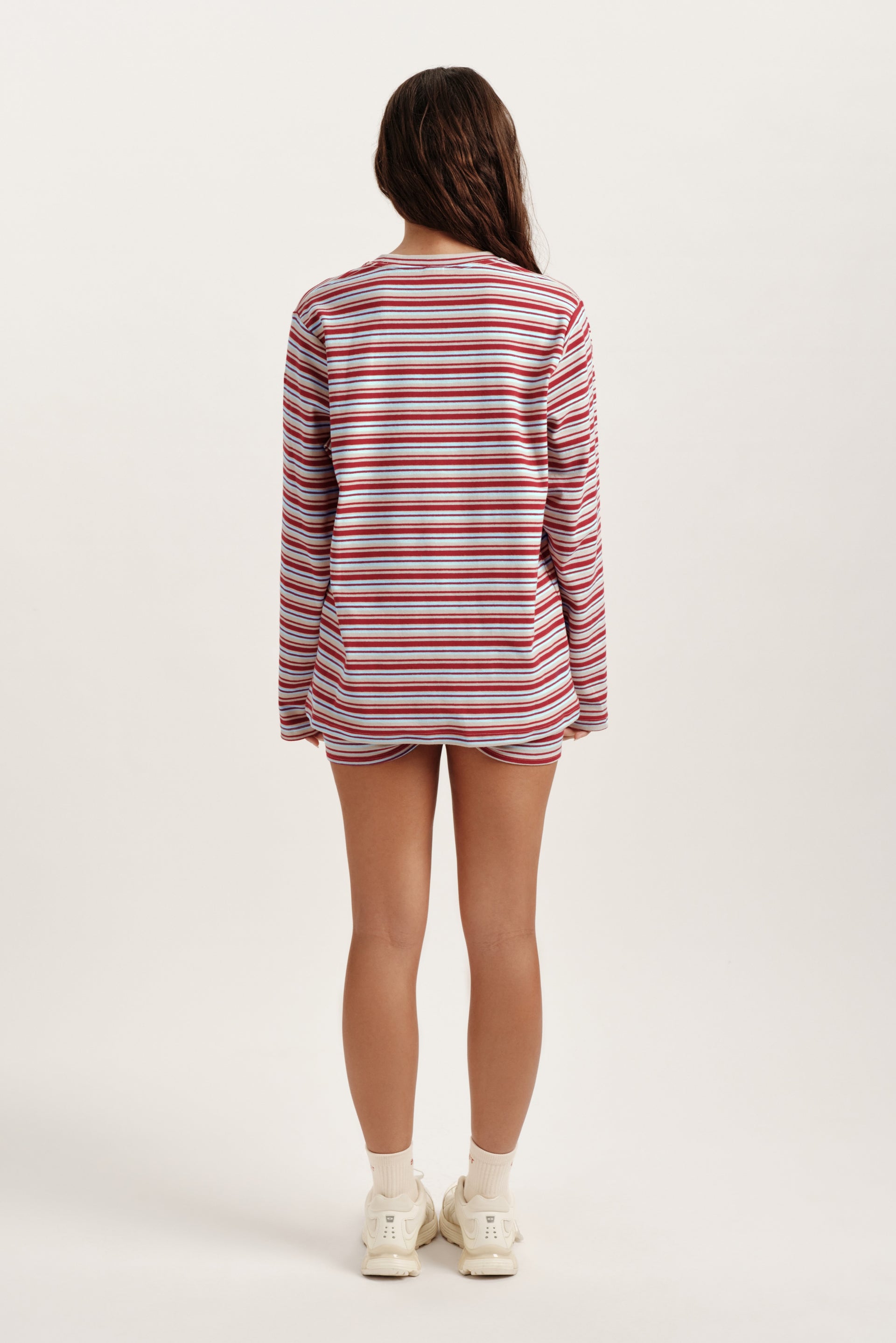 Person wearing a red and white striped shirt on a white background