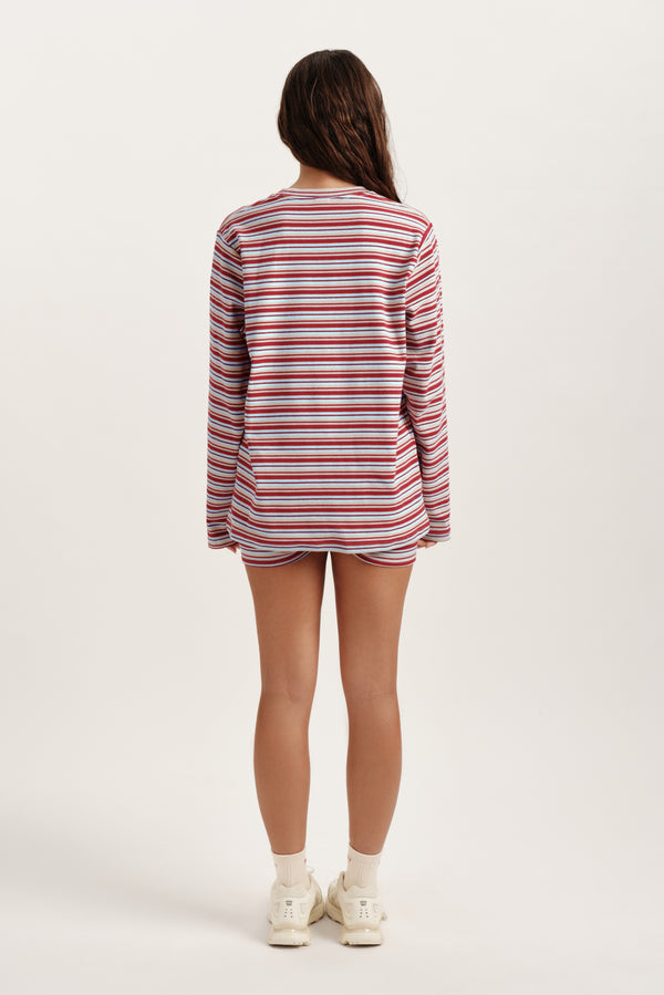 Person wearing a red and white striped shirt on a white background