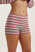 Red and white striped shorts worn by a person on a plain background