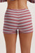 Red and white striped shorts worn by a person on a plain background