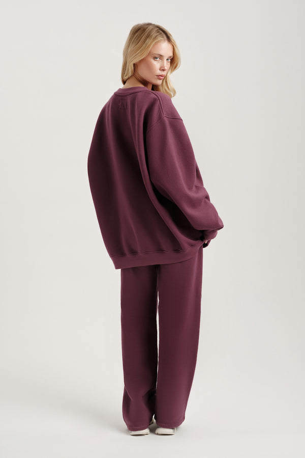 Person wearing a purple outfit on a white background