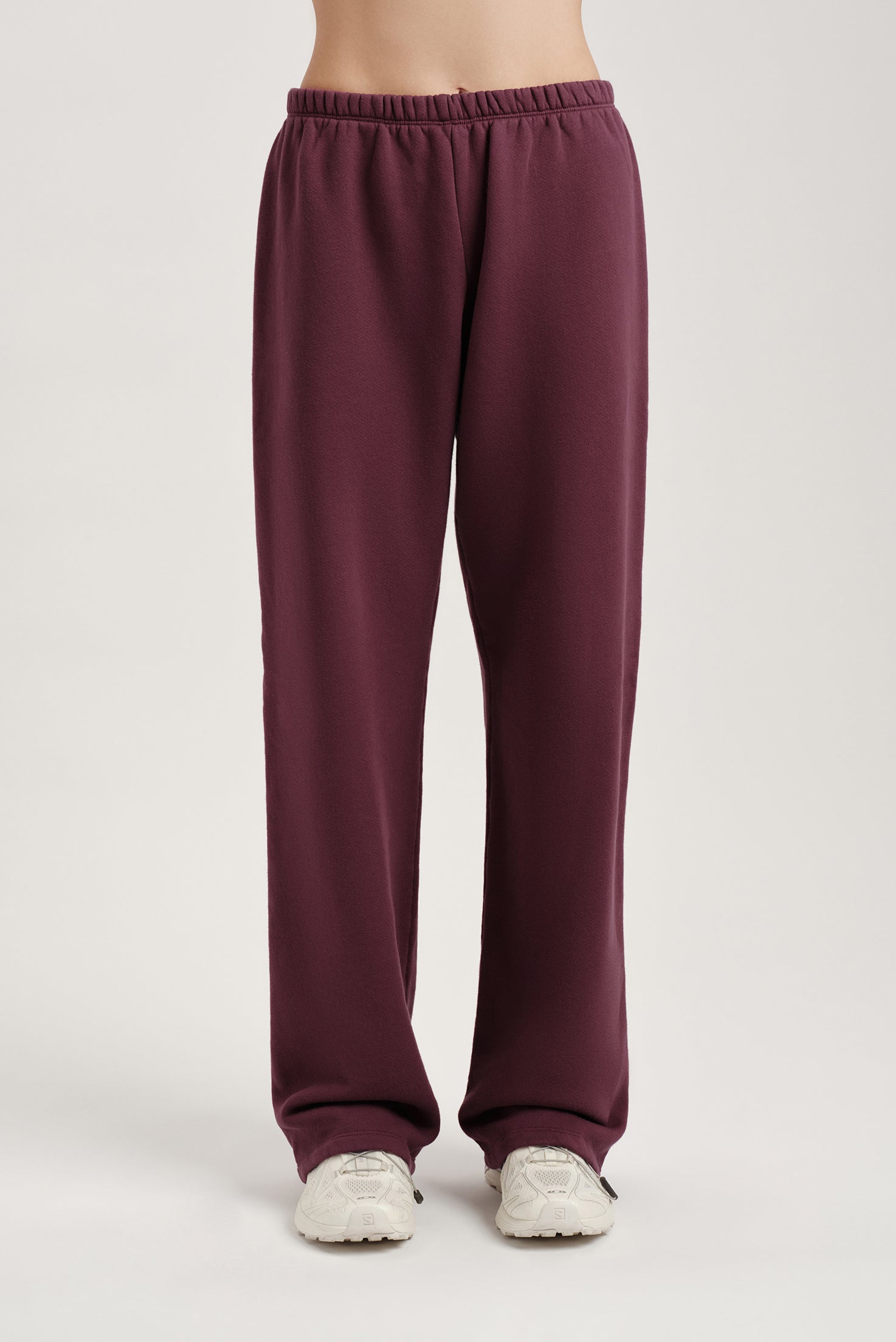 Maroon sweatpants on a plain background
