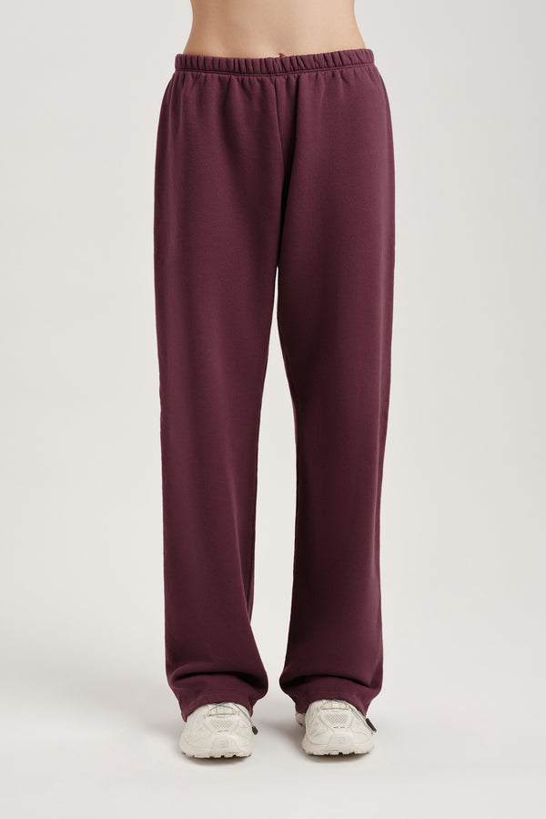 Maroon sweatpants on a plain background