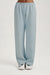 Light blue sweatpants worn by a person on a light gray background