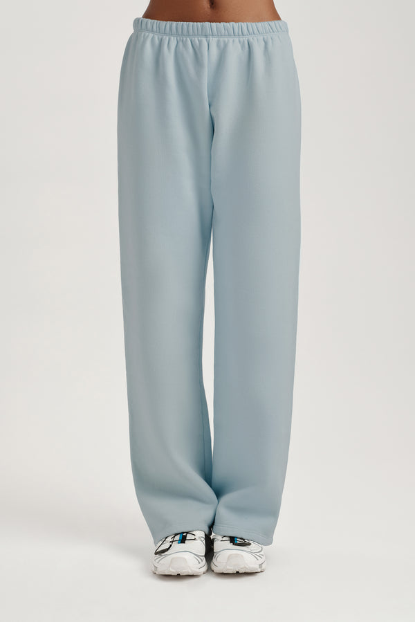 Light blue sweatpants worn by a person on a light gray background