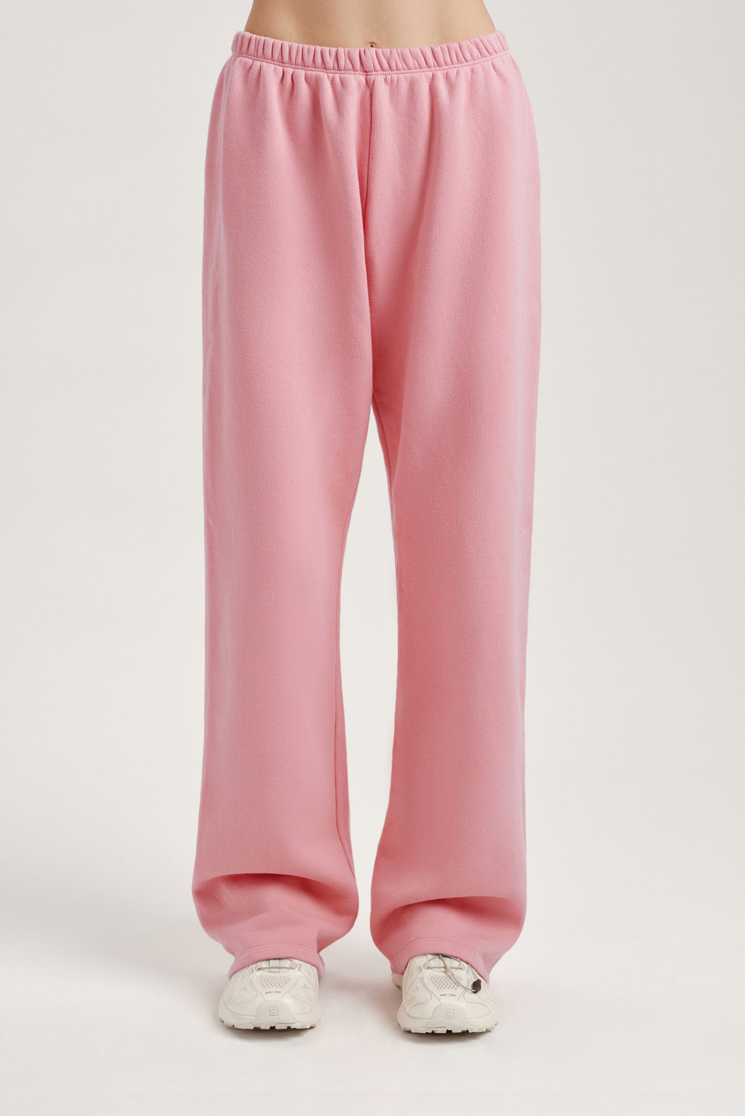 Pink sweatpants on a plain background