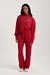 Person wearing a red tracksuit with 'SET' branding on a white background