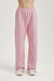 Pink sweatpants worn by a person on a light gray background