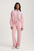Person wearing a pink tracksuit on a white background