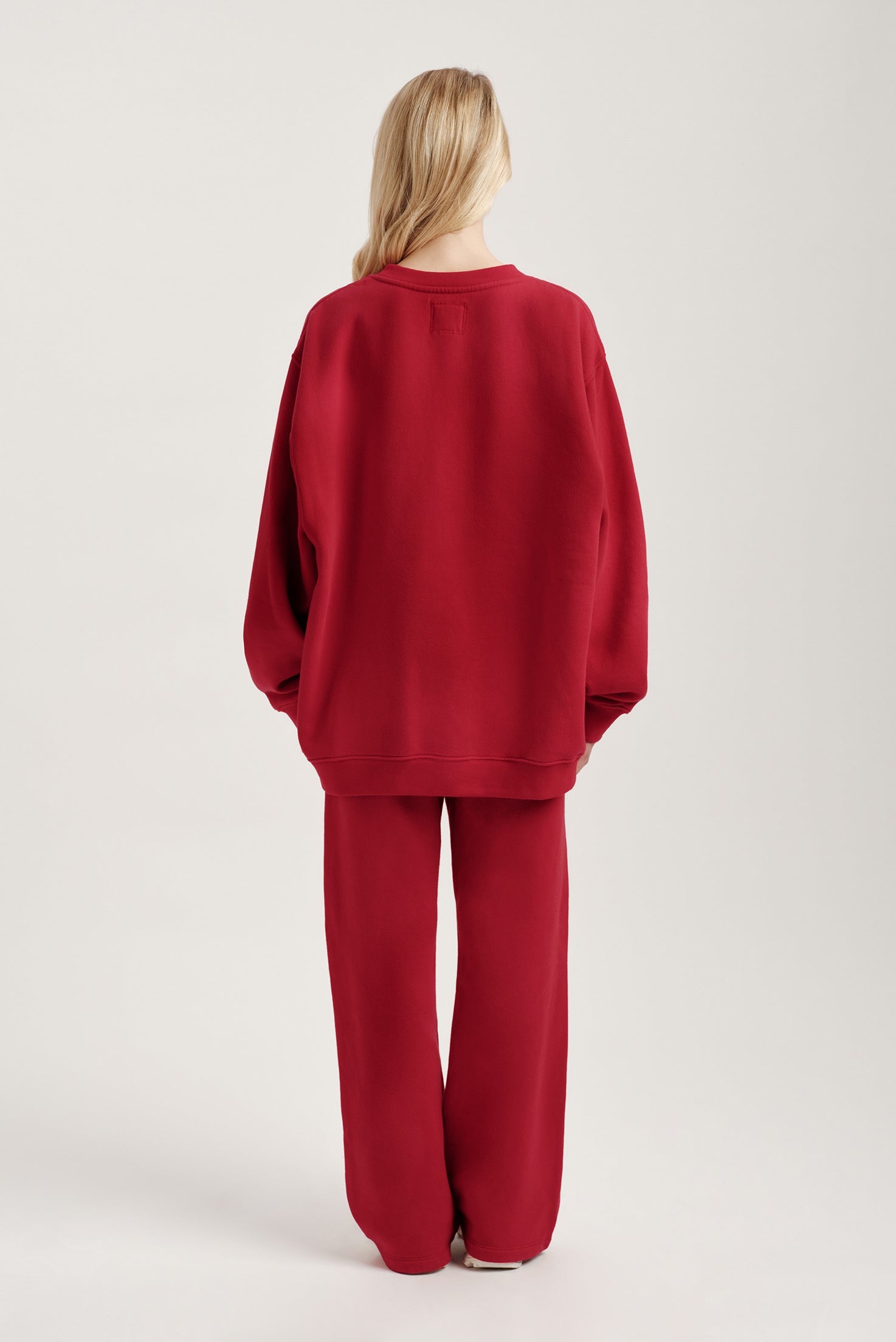 Person wearing a red outfit on a plain background