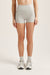 Person wearing gray athletic shorts on a plain background <model-info>Bella wears a size XS and is 5’7, 23” waist, 32AB bust.</model-info>