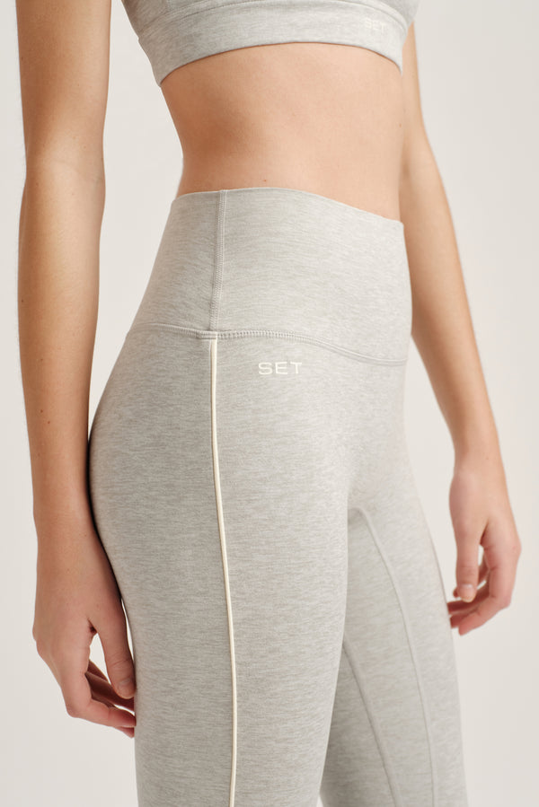 Gray leggings with a brand logo on a white background